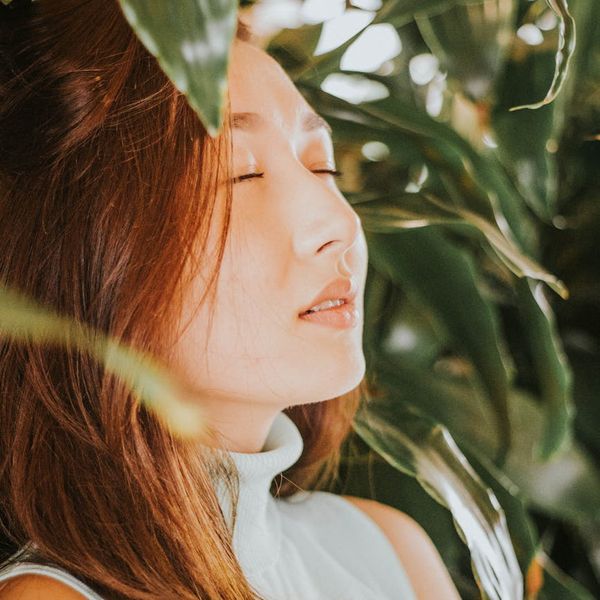 Person meditating in a calm environment with soft lighting.